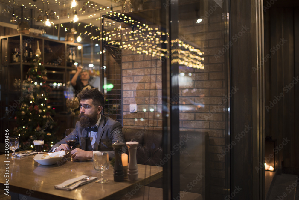 Date meeting of hipster awaiting in pub. Waiting for date of bearded man with wine glass.