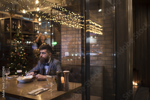 Date meeting of hipster awaiting in pub. Waiting for date of bearded man with wine glass.