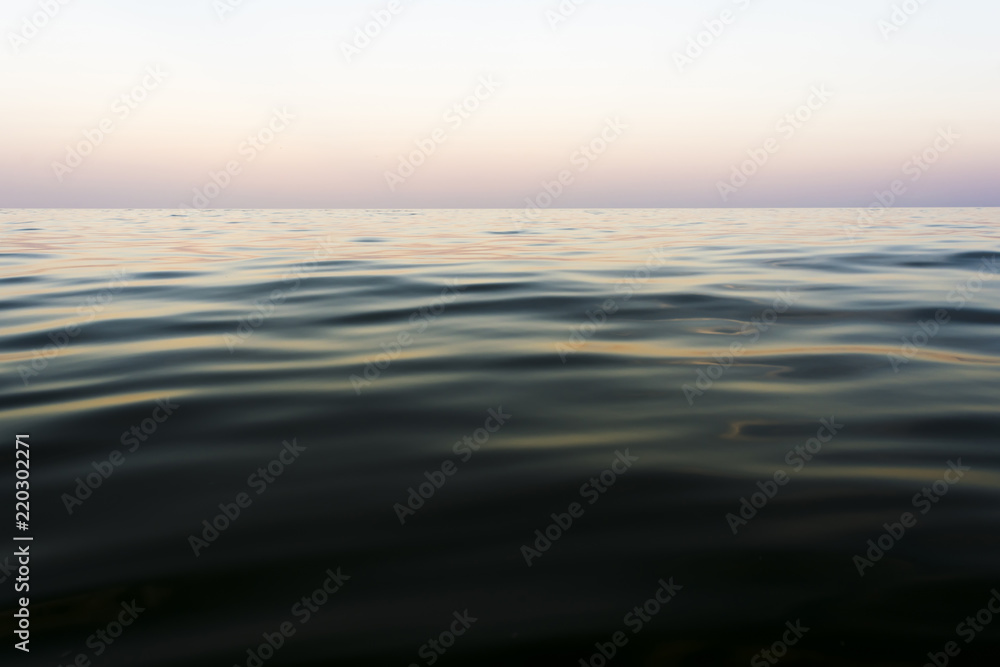 the night sea with waves and reflection of the sky after sunset, sea sky at sunset time, nature abstract background the night sea with waves and reflection of the sky after sunset, sea sky at sunset time, nature abstract background
