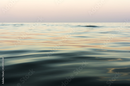 the night sea with waves and reflection of the sky after sunset, sea sky at sunset time, nature abstract background © Aliaksei