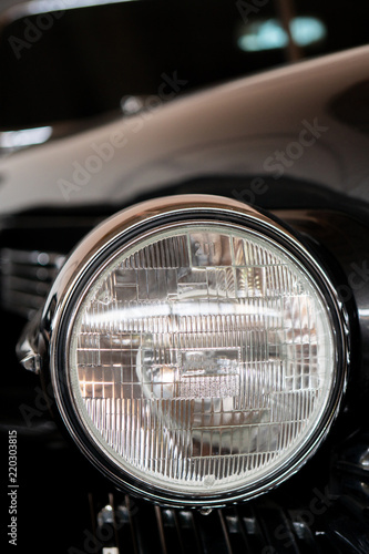 Headlight of an antique, rarity, vintage black car. © sandipruel