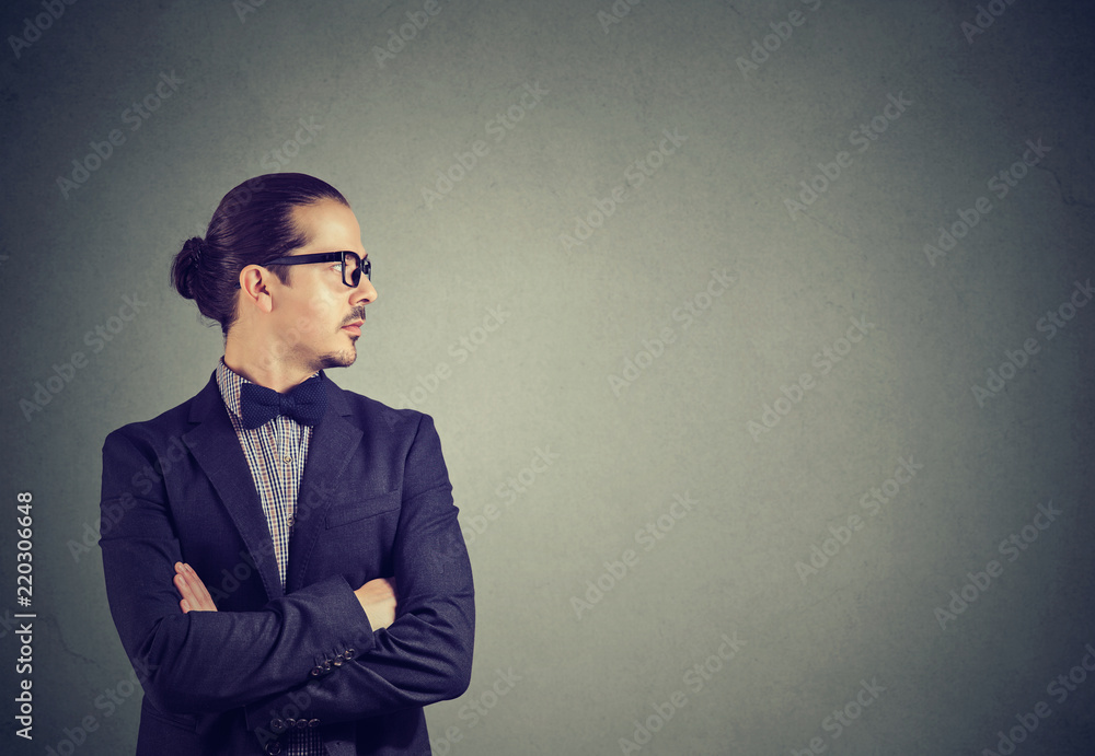 Modern businessman with hands crossed looking away Modern businessman with hands crossed looking away