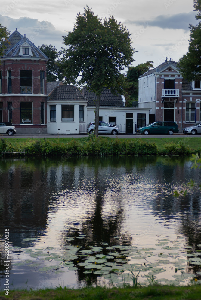 Reflection of typical Dutch houses in canal water