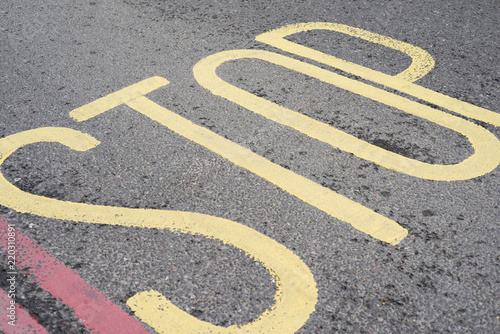 A section of road marking , Stop sign, stop text on the road, marking on the road, special marking