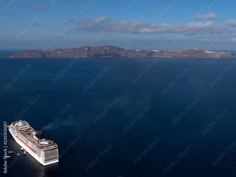 Travelling concept Tourism. Large beautifull cruise ship at sea and nice cloudy sky on background White liner on beautiful sea and mountain background Copy space.
