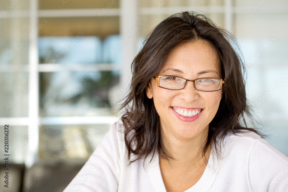 Portrait of an Asian woman smiling wearing glasses. Portrait of an Asian woman smiling wearing glasses.