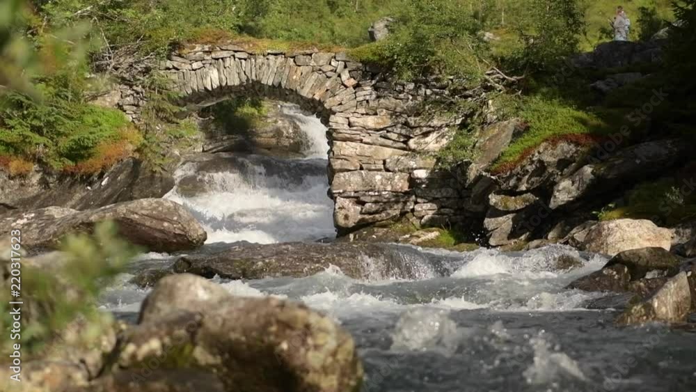 Scenic Scandinavian River and the Stone Bridge in Slow Motion Scenic Scandinavian River and the Stone Bridge in Slow Motion