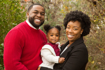 Happy African American family with their baby.