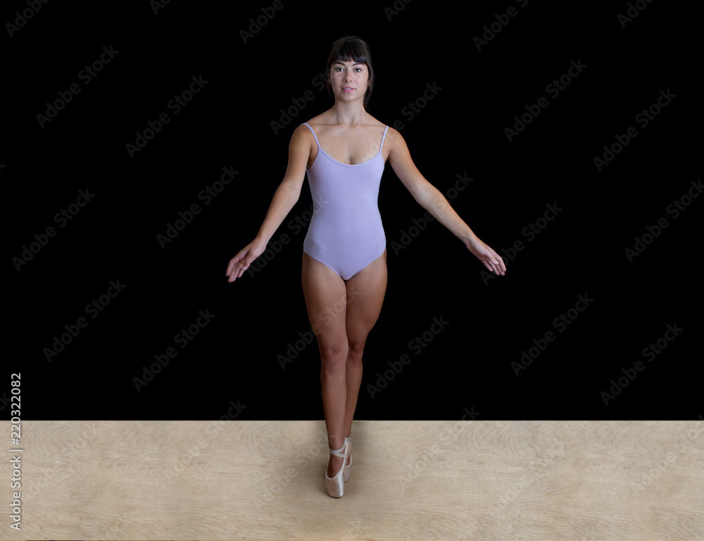 Young Ballerina Dancer in a  Lilac Leotard in a Studio on a Black Backdrop