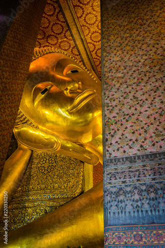 The face of the Reclining Buddha image in Wat Pho, Bangkok, Thailand