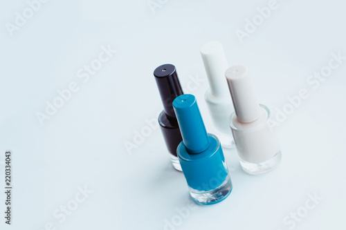 Nail polish of different colors on a light gray background