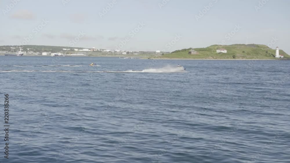 Jet ski riding around near a island Jet ski riding around near a island