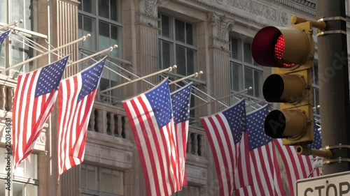 Iconic shot of New York city with American flag, buildings traffic light