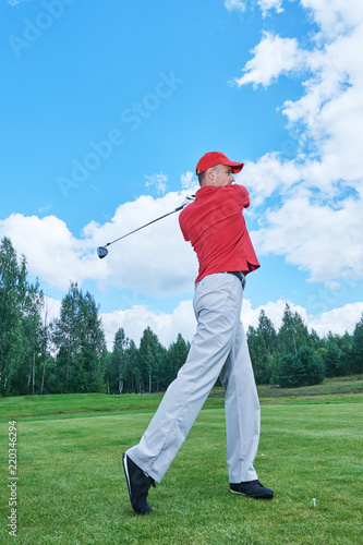 golfer in golf field with club