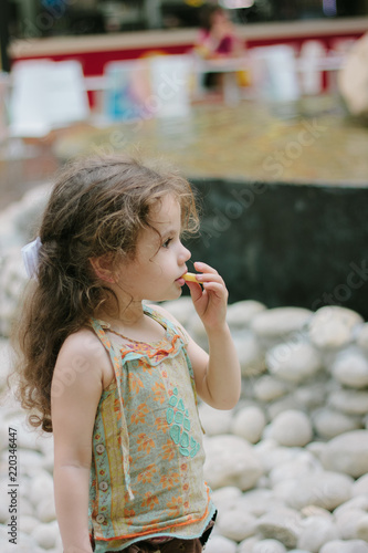 Little girl eating french f...
