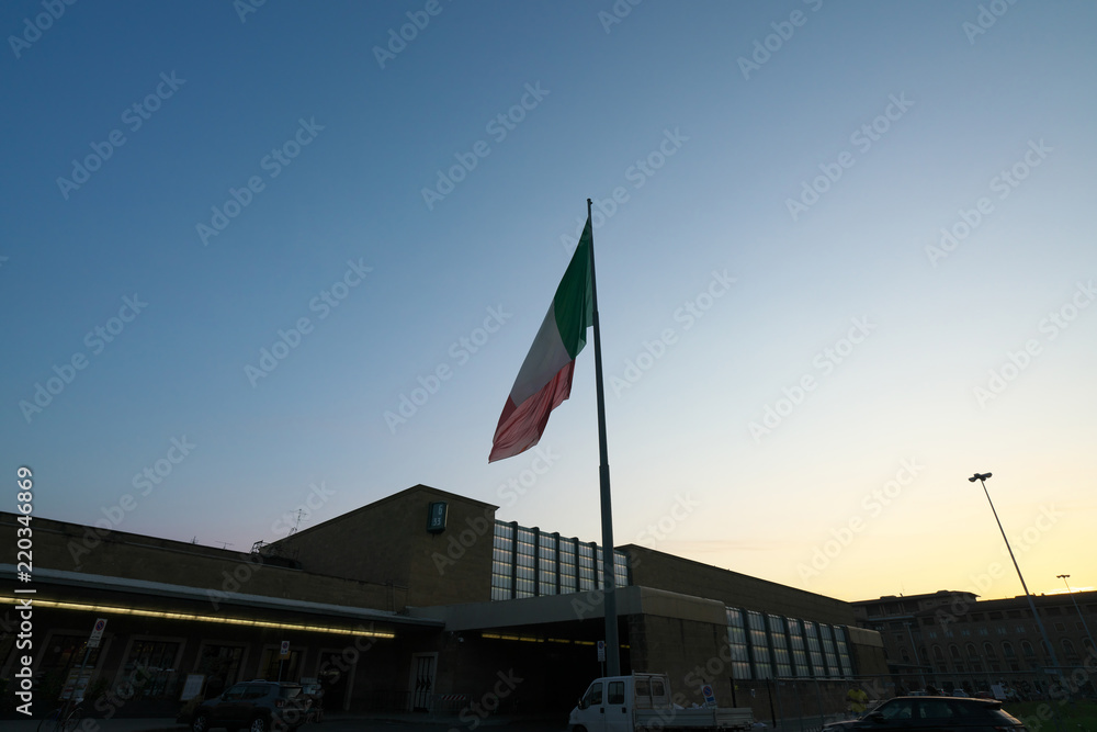 Firenze,Italy-July 26,2018: National flag of Italy flying in the early morning at Firenze Santa Maria Novella station, Florence, Italy
