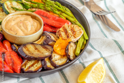 Grilled vegetables on a plate with sauce