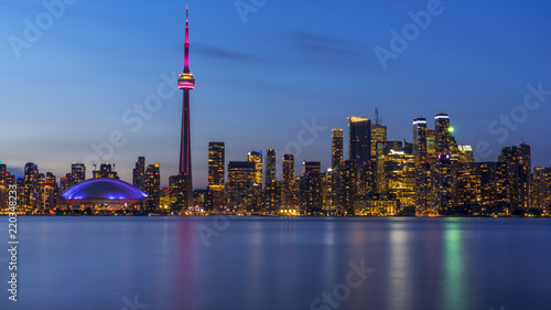 Long exposure of Toronto, Ontario - Canada. Bright sky with a smooth water surface. Beautiful city lights seen from the Toronto Island.