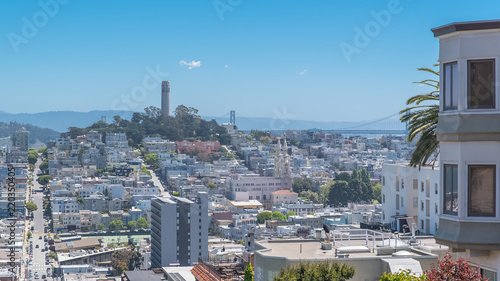 San Francisco, the famous Lombard Street, winding street in Russian Hill, with the Coit tower in background 
