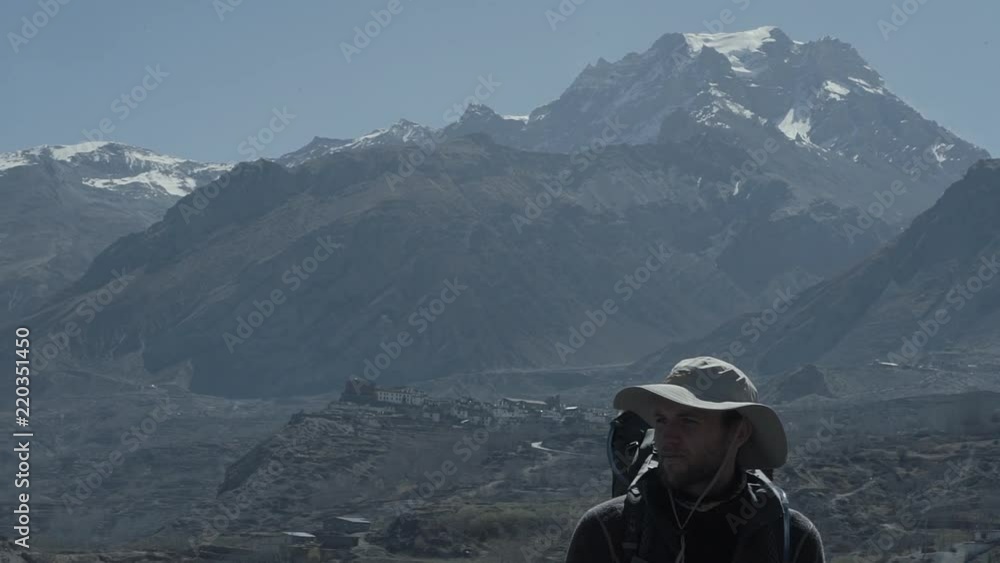 A hiker scans across the landscape near the border of Tibet. A hiker scans across the landscape near the border of Tibet.