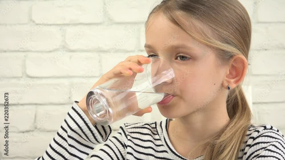 Child Drinking Water in Kitchen, Thirsty Girl Studying Glass of Fresh Water Child Drinking Water in Kitchen, Thirsty Girl Studying Glass of Fresh Water