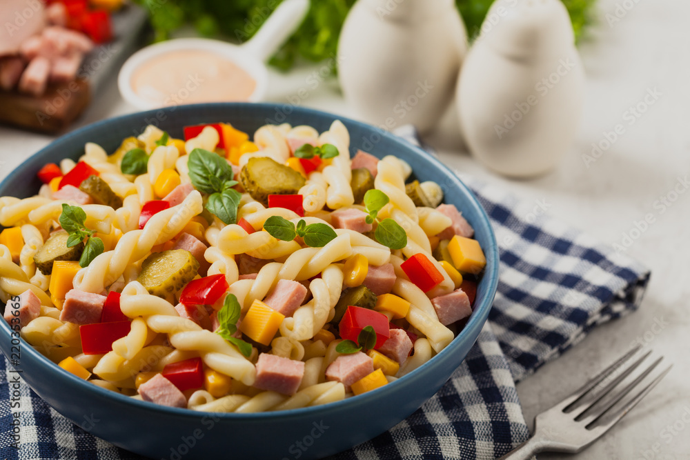 Italian fusilli pasta in a salad with ham and vegetables. Italian fusilli pasta in a salad with ham and vegetables.