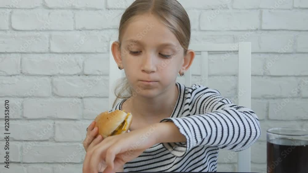 Child Eating Hamburger Drinking Juice in Restaurant, Kid and Fast Food, Children Child Eating Hamburger Drinking Juice in Restaurant, Kid and Fast Food, Children