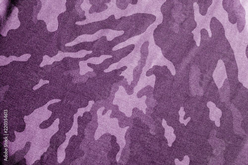 Old camouflage cloth with blur effect in purple tone.