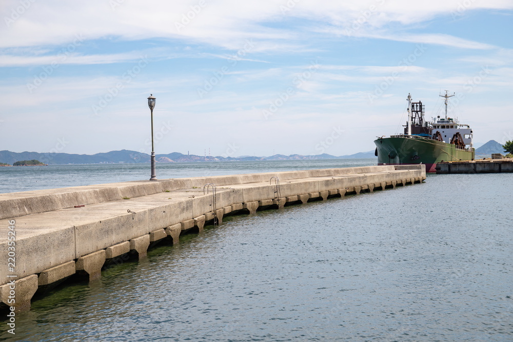 Breakwater and a ship at anchor in the seto inland sea,Kagawa,Shikoku,Japan