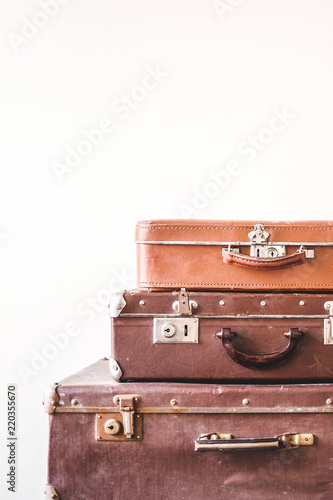 Three old vintage suitcases against a light wall background. Rustic Retro Style