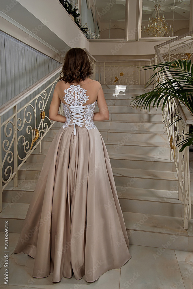 Fototapeta premium Beautiful bride in wedding dress near window