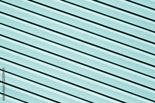 Plastic siding surface in cyan color.