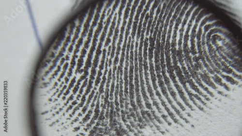 Dactyloscopic expertise of fingerprints. Macro shot.