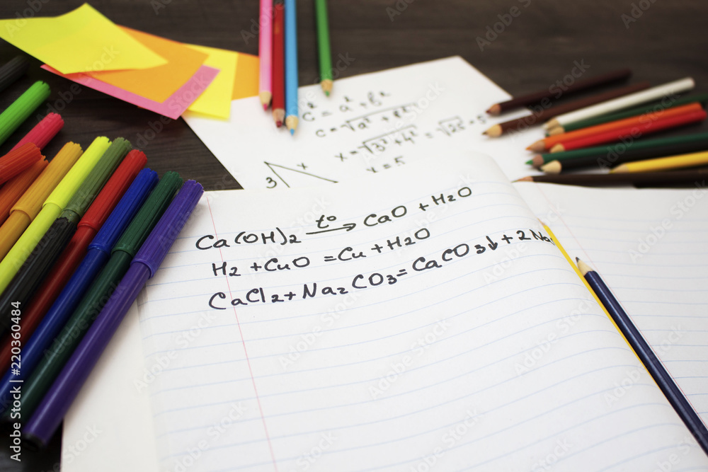 Back to school flat lay. Colour pencils, stickers and lesson notes on wooden background Back to school flat lay. Colour pencils, stickers and lesson notes on wooden background