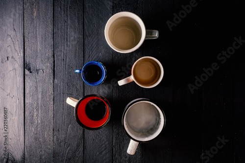 Dirty cups on dark wooden table