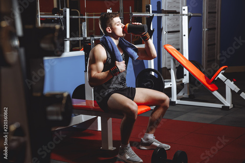 Wallpaper Mural Attractive athletic man resting after training in the gym Torontodigital.ca