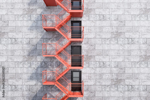 Fotografia Gray bricks building, red fire escape stairs