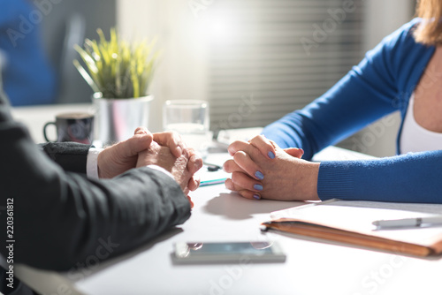Bild auf Leinwand Business negotiation between businesswoman and businessman, light effect