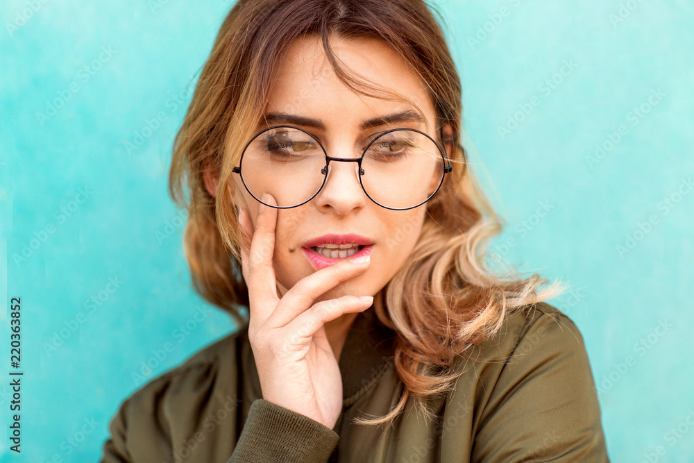 fashion girl posing near a turquoise wooden wall fashion girl posing near a turquoise wooden wall