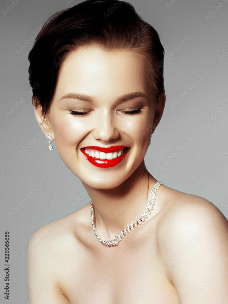 Beautiful girl with set jewelry. Woman in a necklace with a ring, earrings, crown. Accessories. Fashion portrait of young woman with jewelry and elegant hairstyle. Perfect makeup. Beauty style model