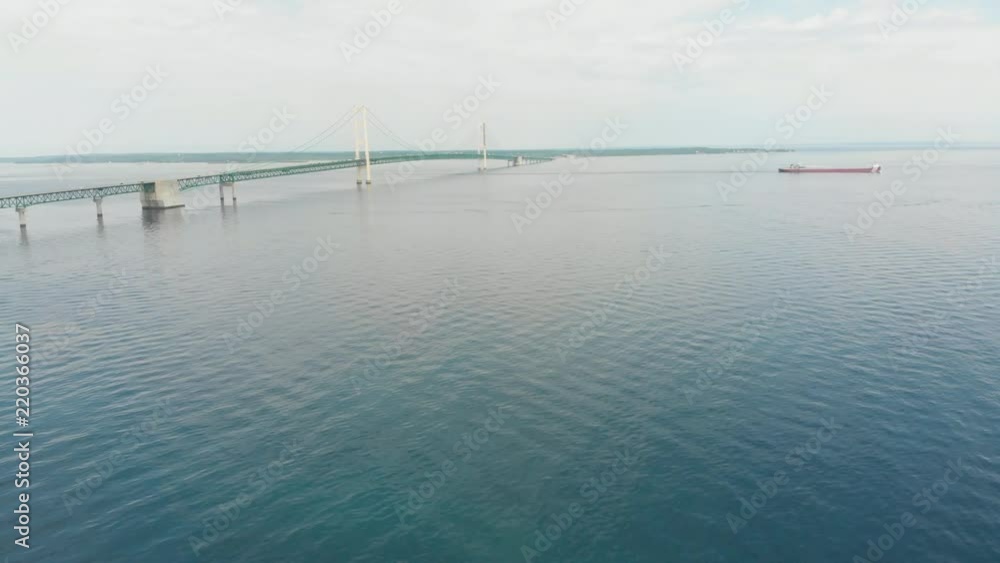Aerial view of Mackinaw City bridge and a large cargo ship that has passed into Lake Huron (Great Lakes) Aerial view of Mackinaw City bridge and a large cargo ship that has passed into Lake Huron (Great Lakes)
