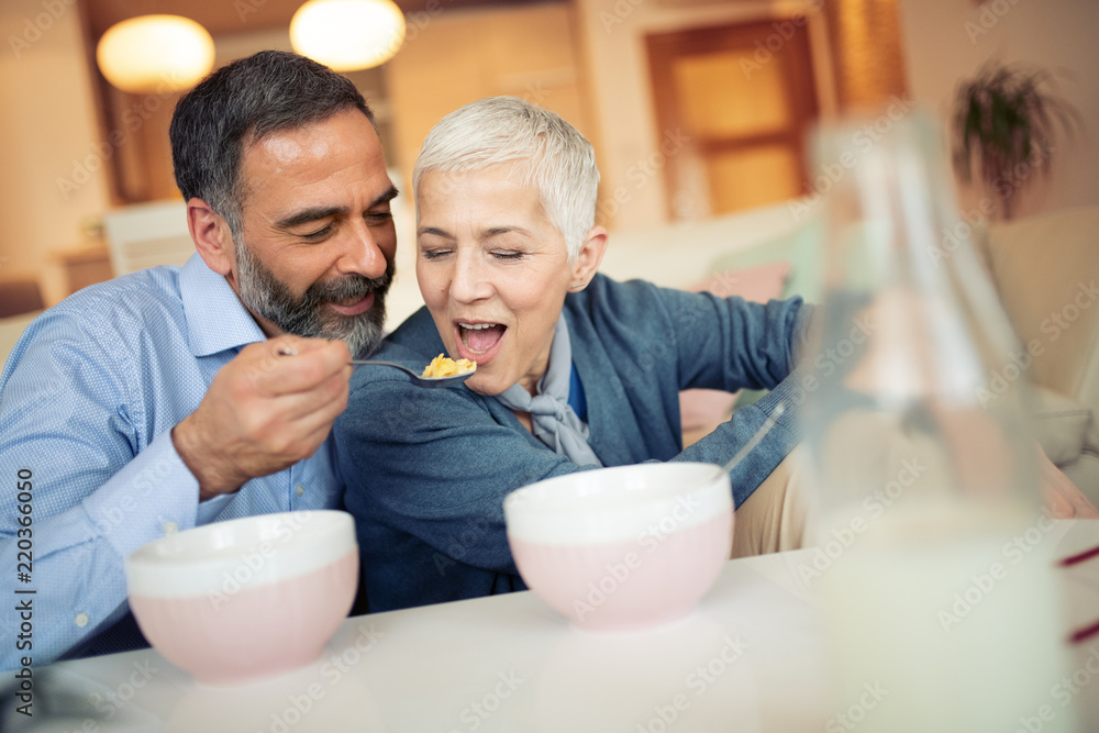 Mature couple eating cornflakes Mature couple eating cornflakes