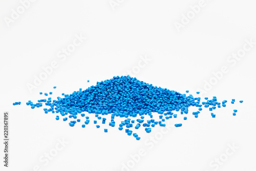 Stack of a blue plastic polymer granules on a white background, copy space photo