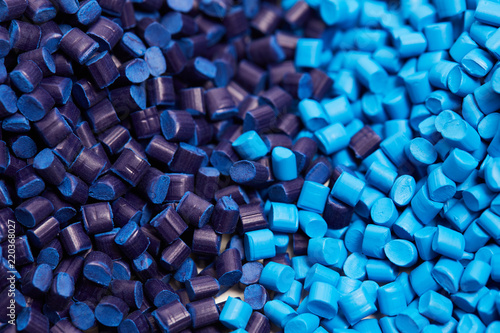 Close up of a two stacks of blue plastic polypropylene granules on a table photo