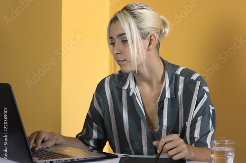 Freelancer working online with a laptop at home photo