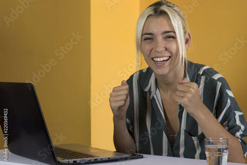 Excited businesswoman looking at camera photo
