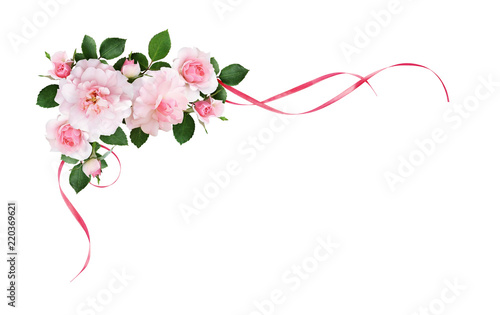 Pink rose flowers and silk waved ribbons in a corner arrangement