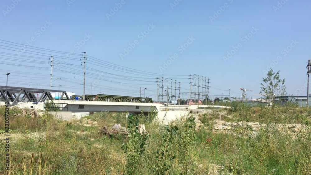 Train bridges and power supply lines next to nature. Conflicting use of development. 4K. Train bridges and power supply lines next to nature. Conflicting use of development. 4K.