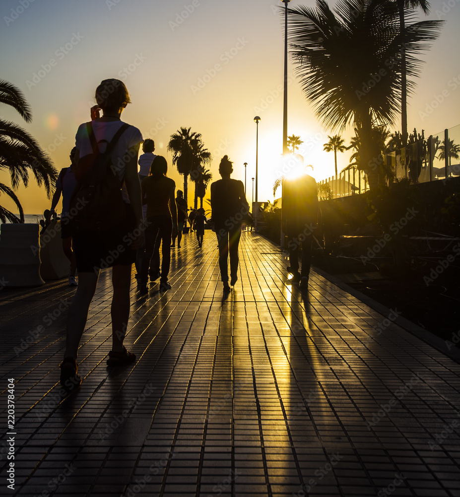 people walking on sunset street 