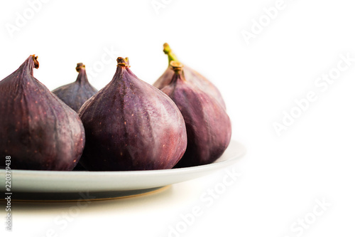 Fresh figs on grey plate isolated on white